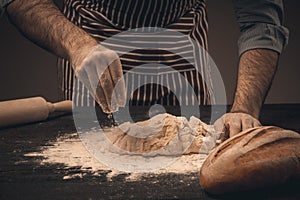 Male hands knead the dough.