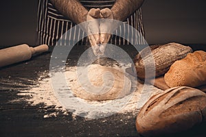 Male hands knead the dough.