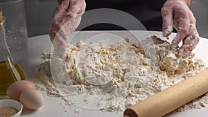 Male hands kneading dough for bakery. Chef making dough for pizza in kitchen. Preparation process