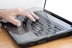Male hands at laptop keyboard