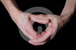 Male hands making heart gesture on black background, isolated image, love confession concept, relationship symbol, valentine`s da