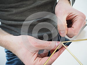 Male hands making a metal structure