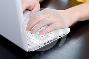 Male hands on a notebook keyboard