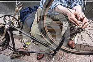 Male hands on old bicycle vintage, grunge chain detail