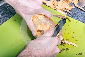 Male hands peeling sweet potatoes