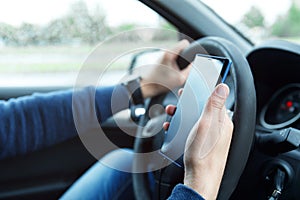 Male hands with phone. Man in car is using smartphone.