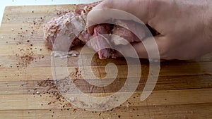 Male hands pickling meat on the kitchen. First-person view.