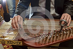Male Hands Playing Arabian Qanon Musical Instrument photo
