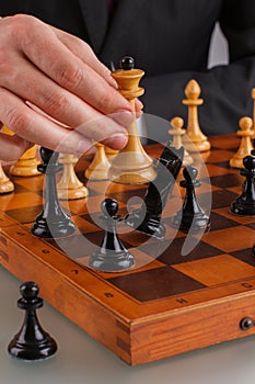 Male hands playing chess close up.