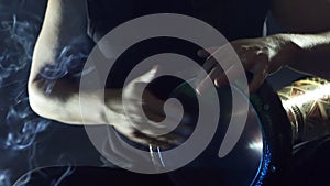 Male hands playing on darbuka, slow rhythm, incense