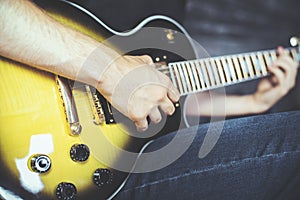 Male hands playing electric guitar