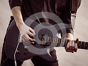 Male hands playing electric guitar