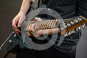 Male hands playing electric guitar