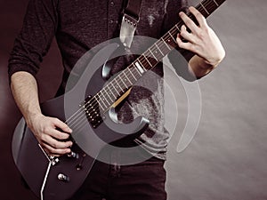 Male hands playing electric guitar