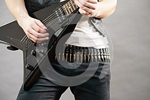 Male hands playing electric guitar