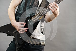 Male hands playing electric guitar