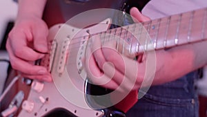 Male hands playing electric guitar. Man with a musical instrument. Riffs and chords. Guitarist of rock-n-roll band. HD