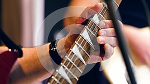 Male hands playing a guitar solo. Closeup