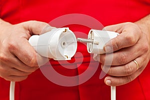 Male hands plugging or unplugging electrical wires photo