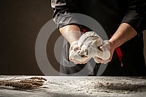 Male hands preparing dough for pizza on table closeup. Food concept