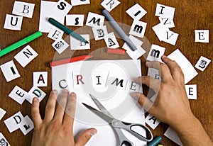 Male hands put together letters in word - Crime.