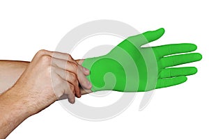 Male hands putting on green medical gloves isolated on white background