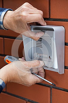 Male hands repairing intercom