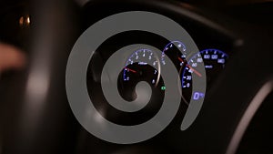 Male hands rotating car steering wheel. Close up of man driving car in night city.