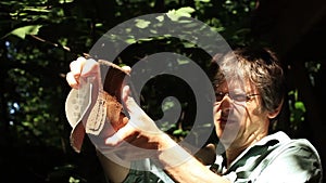 Male hands sharpening dirty old rusty axe with a grindpaper