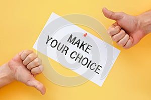 Male hands show signs of approval or disapproval. Postcard with the inscription Make your choice