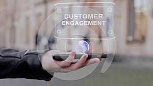 Male hands show on smartphone conceptual HUD hologram Customer engagement