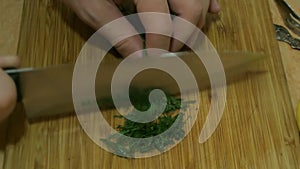 Male hands slicing dill. Russian cuisine.