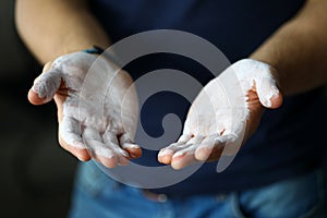 Male hands smeared with magnesium powder ready to workout