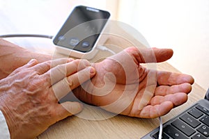 male hands with special device blood pressure measurement, cardiovascular health monitoring, heart rate monitoring, hypertension