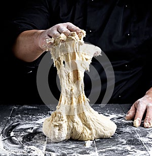 Male hands substitute white wheat flour dough