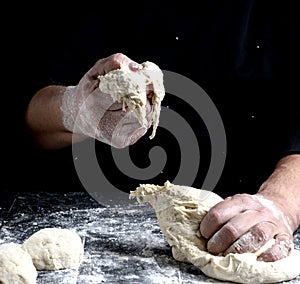 Male hands substitute white wheat flour dough