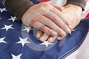Male hands touch the flag of the United States of America