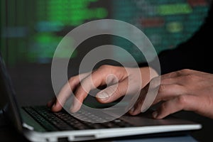 Male hands typing computer code, security program for database or servers