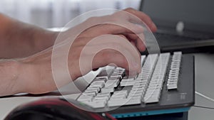 Male hands typing on computer keyboard