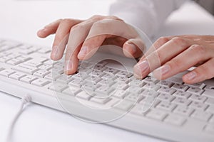 Male hands typing on a computer keyboard