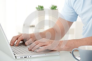 Male hands typing on keyboard