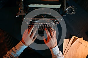 Male hands typing on retro typewriter