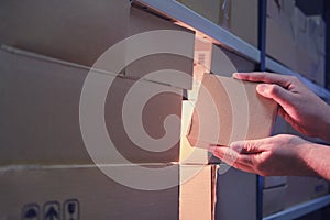 Male hands in a warehouse with box, night theft