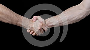 Male handshake. Gestures. black background. Man's hands. Greetings and farewell.