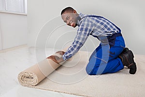 Male Handyman Rolling Carpet