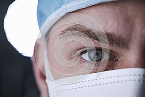 Male healthcare worker in scrubs head shot, close up crop
