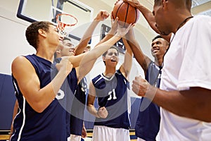 Male High School Basketball Team Having Team Talk With Coach photo