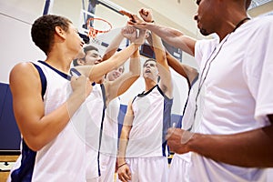 Male High School Basketball Team Having Team Talk With Coach