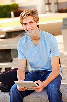 Male High School Student Using Digital Tablet Outdoors