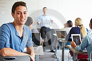 Male High School Student Using Laptop In Classroom